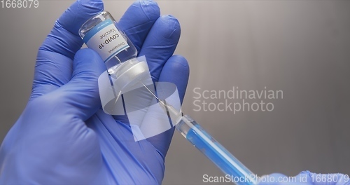 Image of Vaccine in human hands closeup footage