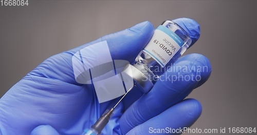 Image of Vaccine in human hands closeup footage