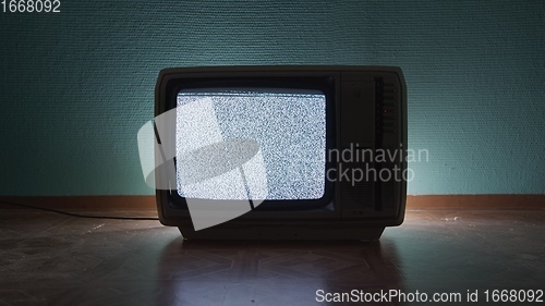 Image of Old TV agains green background