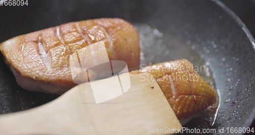 Image of Roast duck breast in frying pen closeup footage