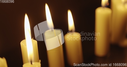 Image of Candles glowing against dark background