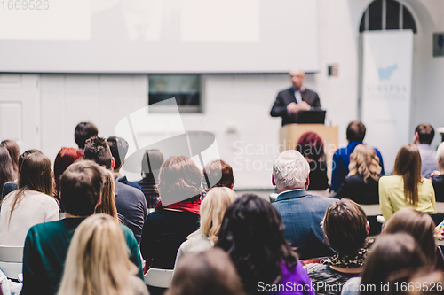 Image of Public speaker giving talk at Business Event.