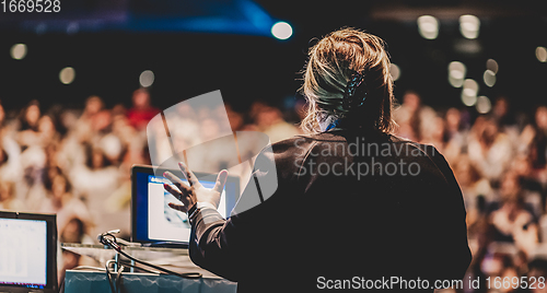 Image of Public speaker giving talk at Business Event.