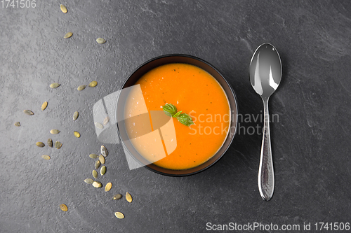 Image of vegetable pumpkin cream soup in bowl with spoon