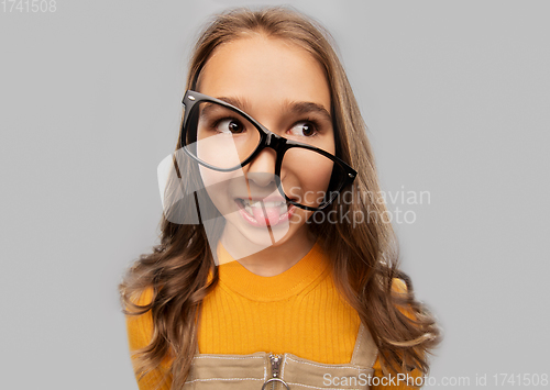 Image of smiling teenage student girl in glasses