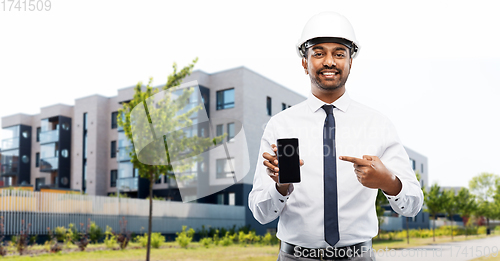 Image of architect showing smartphone on city street