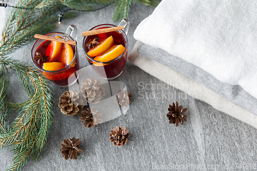 Image of mulled wine with orange and spices, cones and fir