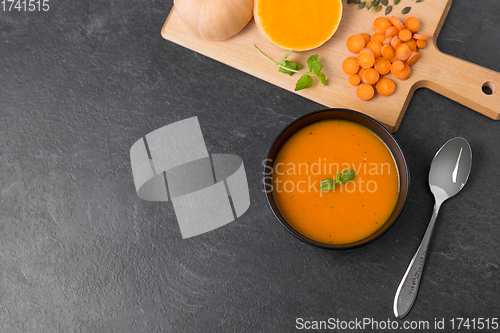 Image of vegetable pumpkin cream soup in bowl with spoon