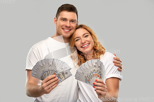 Image of happy couple in white t-shirts with dollar money