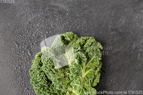 Image of close up of kale cabbage on slate background