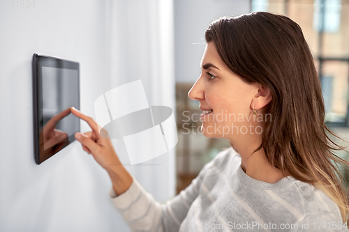 Image of woman using tablet computer at smart home