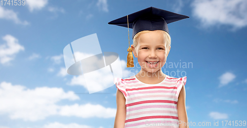 Image of happy girl in bachelor hat or mortarboard over sky