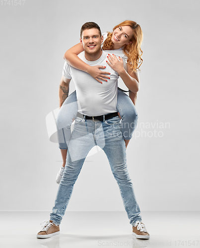 Image of happy couple in white t-shirts having fun