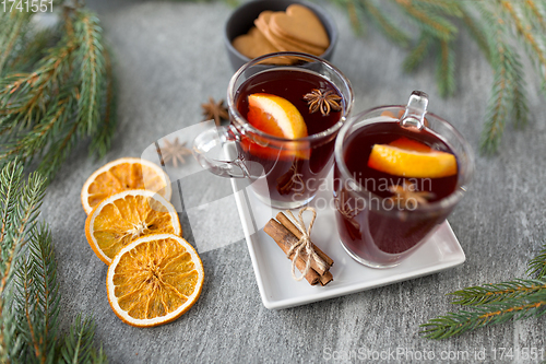 Image of mulled wine, orange slices, gingerbread and spices