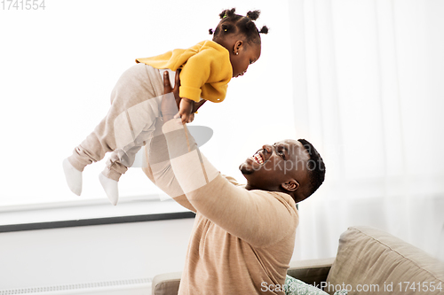 Image of happy african american father with baby at home