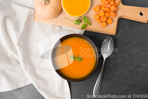 Image of vegetable pumpkin cream soup in bowl with spoon