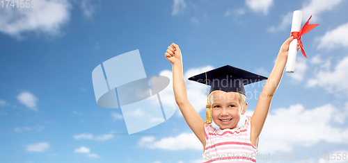 Image of happy little girl in mortarboard with diploma