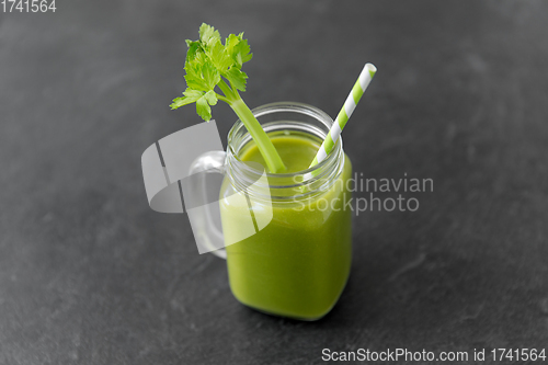 Image of close up of glass mug with green celery juice