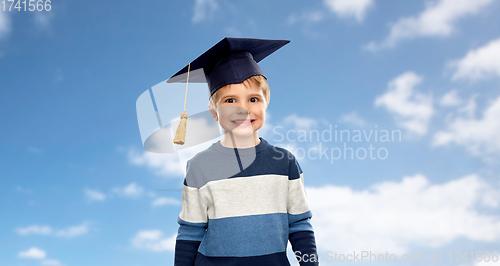 Image of little boy in bachelor hat or mortarboard over sky