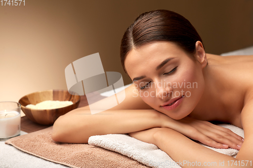 Image of young woman lying at spa or massage parlor