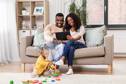 Image of family with tablet pc and toy blocks at home