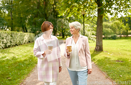 Image of senior women or friends drinking coffee at park