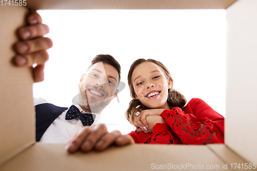 Image of happy couple looking into open christmas gift box