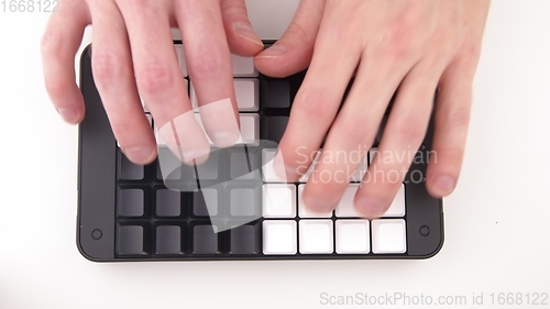 Image of Hands typing fast on Unlabeled keyboard