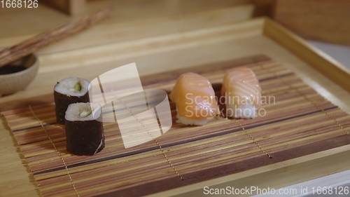 Image of Filling plate with japanese sushi closeup