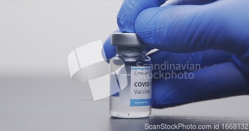 Image of Vaccine in human hands closeup footage