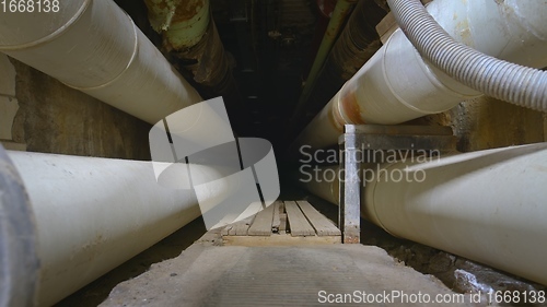 Image of Dark underground tunnel made out of pipes