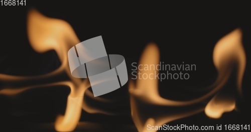 Image of Fire dancing against dark background 120fps slow motion loopable footage