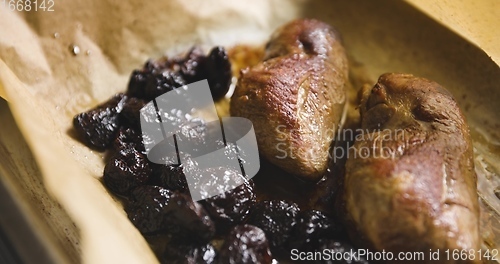 Image of Roast duck breast with plums prepared motion footage closeup