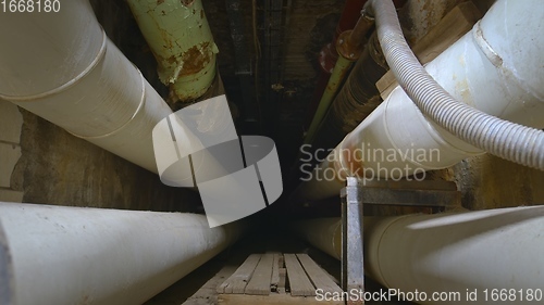 Image of Dark underground tunnel made out of pipes