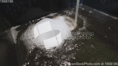 Image of Foam and water whirling in wash basin