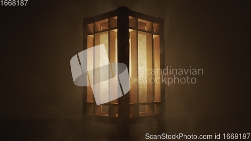 Image of Lamp made out of wood against dark background with smoke