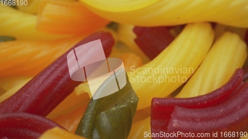 Image of Whole grain colorful pasta in camera motion