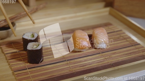 Image of Filling plate with japanese sushi closeup