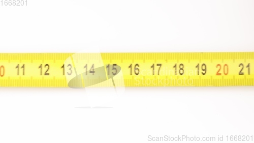 Image of Extending measuring tape on white background