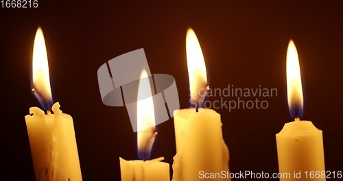 Image of Candles glowing against dark background