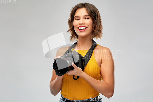 Image of happy woman photographer with digital camera