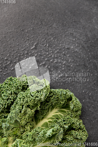 Image of close up of kale cabbage on slate background