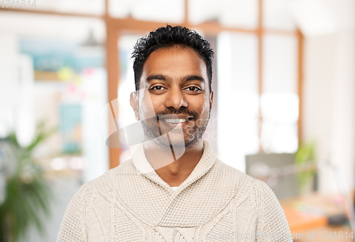 Image of indian man in sweater over office background