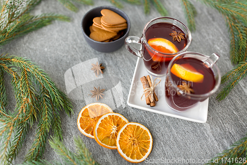 Image of mulled wine, orange slices, gingerbread and spices