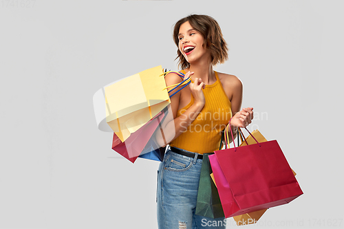 Image of happy smiling young woman with shopping bags