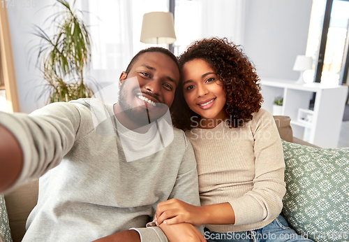 Image of african american couple taking selfie at home