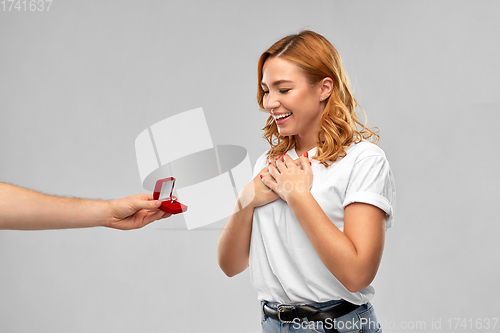 Image of man giving woman engagement ring on valentines day