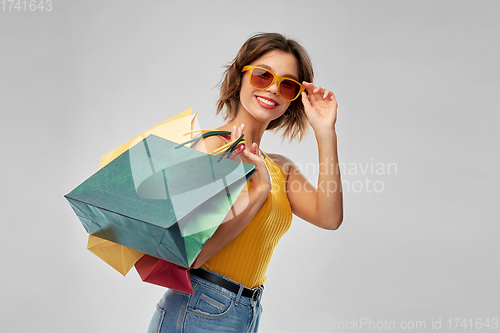 Image of happy smiling young woman with shopping bags