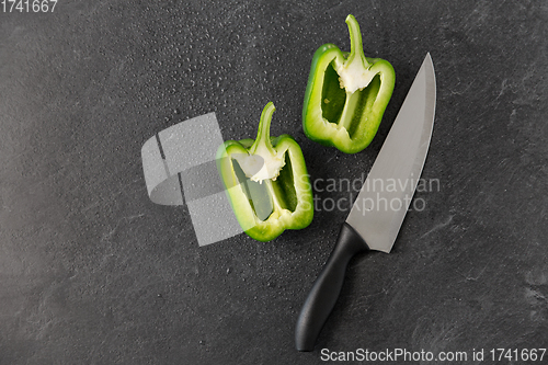 Image of green pepper and kitchen knife on slate background