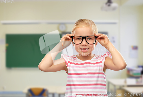 Image of smiling cute little girl in black glasses